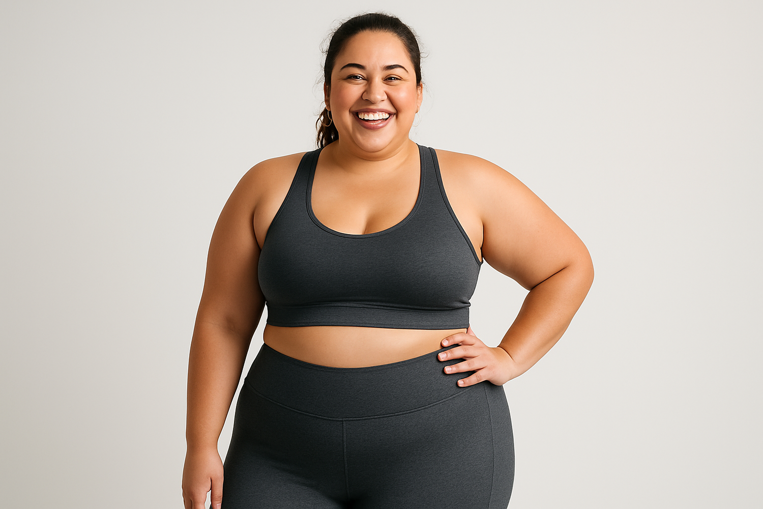 Plus size model girl in workout outfit smiling 